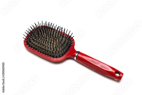 old red hairbrush with sticking out hair