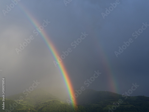 rainbow over green mountains