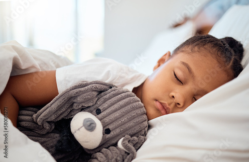 Foto Peace, morning and wellness of black child sleeping in cozy bed with toy teddy in home on the weekend
