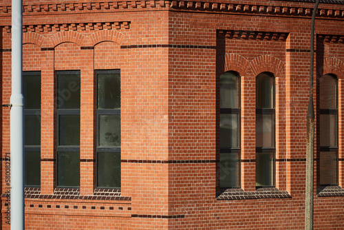 Red brick wall with large windows. Wroclaw, Poland.