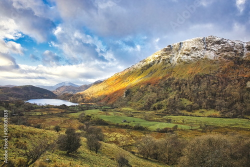 A view of Nant Gwynant (Mount Gwynant) in the Snowdonia national park in Wales in the late autumn with golden colours and snow photo