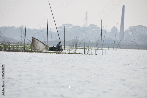 A fisherman fishing in Rudrasagar lake , Tripura, India. photo