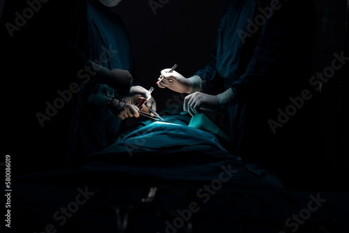 Fotografie Surgical team performing surgery to patient in sterile operating room