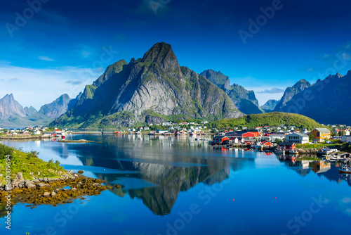 Perfect reflection of the Reine village on the water of the fjord in the Lofoten Islands,  Norway