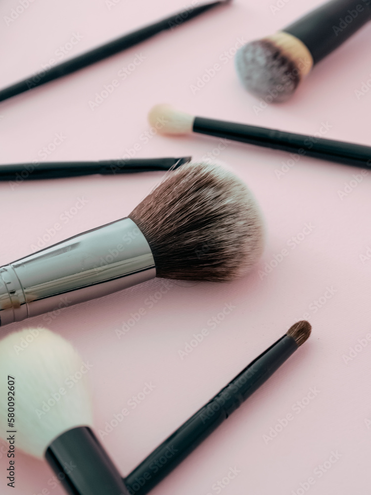 Set of cosmetic brushes on a pink background. Makeup brushes. Makeup tool. Beauty concept. Place for text. Copy space. Flat lay. Set of cosmetic brushes on a pink background. Makeup brushes. Makeup tool. Beauty concept. Place for text. Copy space. Flat lay.