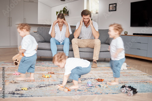 Parents, stress and busy with an adhd child running around a home living room with energy or motion blur. Family children and headache with a hyperactive kid in a lounge with a stressed mom and dad photo