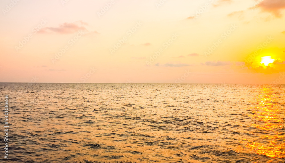 Beautiful sunsets sky, sun through the clouds over with tranquil seascape. Horizon over the water.