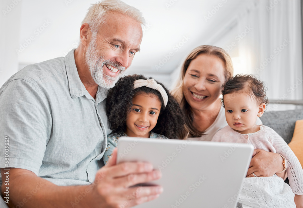 Family, tablet and online browsing with senior people babysitting grandchildren in the family home. Grandfather, grandmother and grandkids with a digital tablet for streaming internet media Family, tablet and online browsing with senior people babysitting grandchildren in the family home. Grandfather, grandmother and grandkids with a digital tablet for streaming internet media