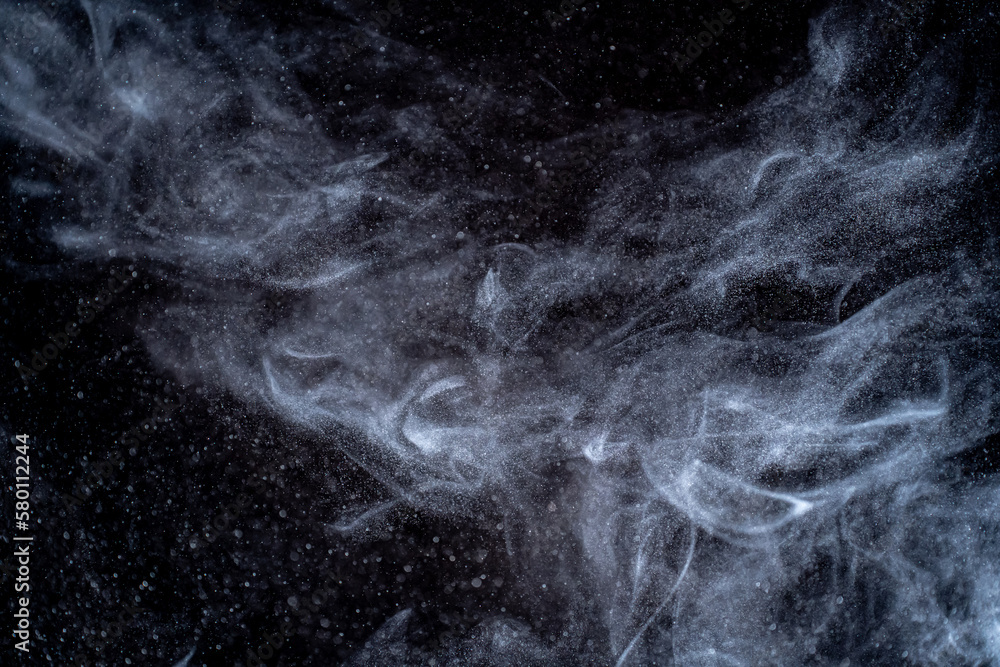 Dust particles cloud generating abstract shape on black background with copy space for text, web, design or banner. Dust particles cloud generating abstract shape on black background with copy space for text, web, design or banner.