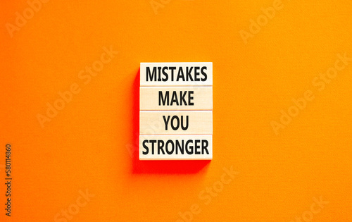 Mistake make stronger symbol. Concept words Mistakes make you stronger on wooden blocks. Beautiful orange table orange background. Business mistake make stronger concept. Copy space.