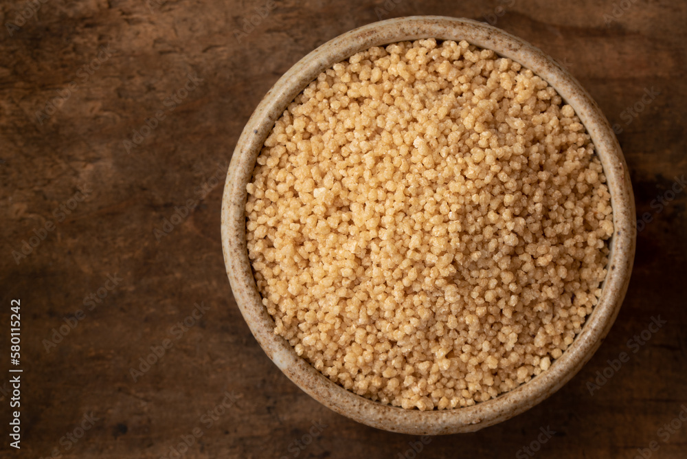 Uncooked Whole Wheat Couscous in a Bowl Uncooked Whole Wheat Couscous in a Bowl