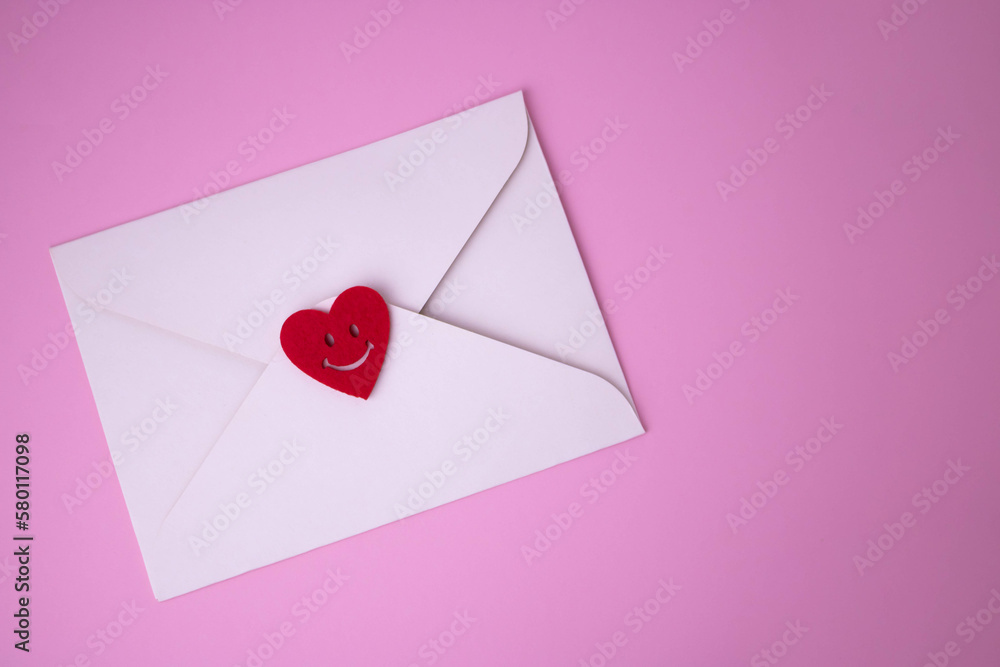 White envelope with red hearts for Valentine's Day on a pink background. The concept of a love message for March 8, Mother's Day, Father's Day, family Day White envelope with red hearts for Valentine's Day on a pink background. The concept of a love message for March 8, Mother's Day, Father's Day, family Day