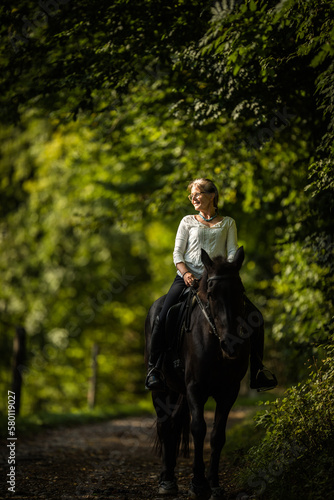 Woman riding a horse. Equestrian sport, leisure horse riding concept