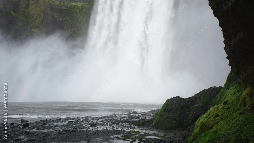 Skogafoss waterfall in Iceland, Water flowing through cliffs, Famous attraction. Huge mountain river. Nature spring landscape. Shot in 8k resolution 4320p. Skogafoss waterfall in Iceland, Water flowing through cliffs, Famous attraction. Huge mountain river. Nature spring landscape. Shot in 8k resolution 4320p.