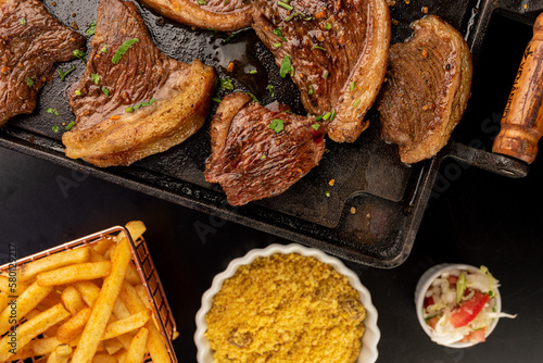 Food - Picanha on the plate with farofa, vinaigrette and fries photo