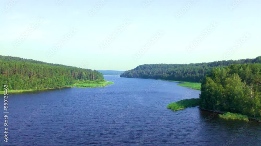 Beautiful landscape - islands covered with green coniferous forest, surrounded by blue lakes. Observe natural nature without people from above. Beautiful landscape - islands covered with green coniferous forest, surrounded by blue lakes. Observe natural nature without people from above.