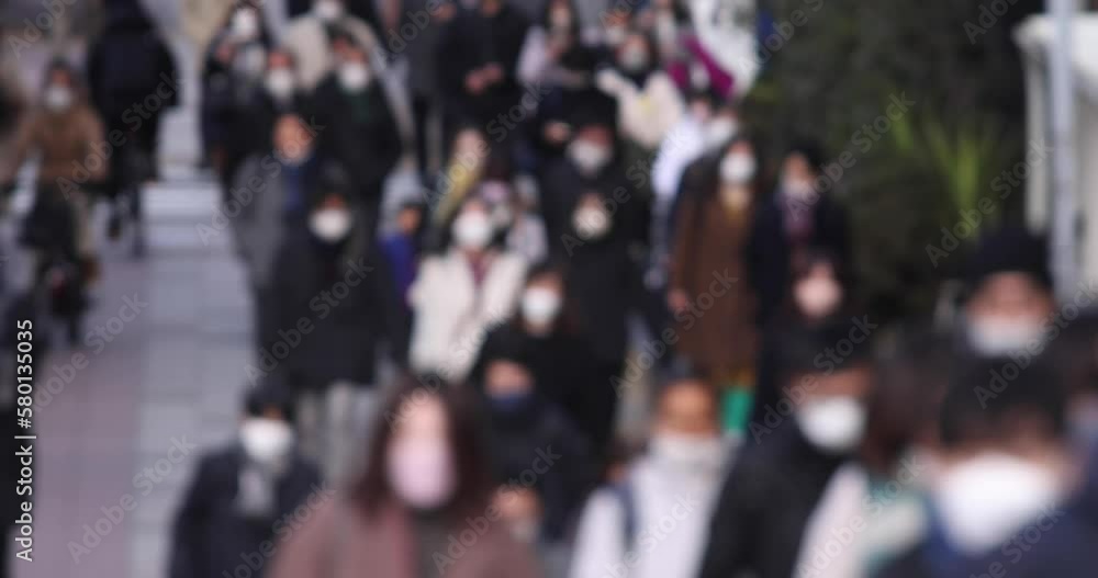 A crowd of walking people on the city street defocused A crowd of walking people on the city street defocused