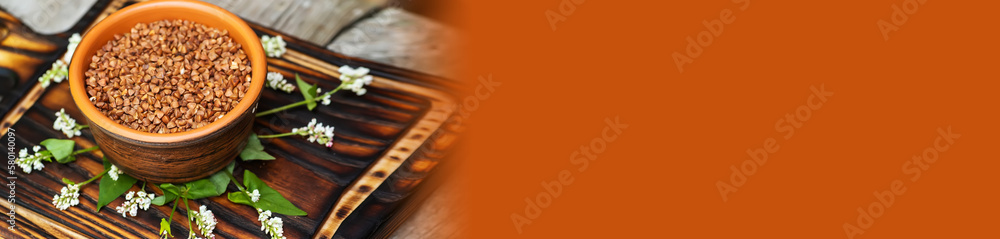 Buckwheat flowers on a wooden table. Dry ingredients for the preparation of buckwheat porridge. Peeled seeds of pseudo-zlaks. Buckwheat flowers on a wooden table. Dry ingredients for the preparation of buckwheat porridge. Peeled seeds of pseudo-zlaks.