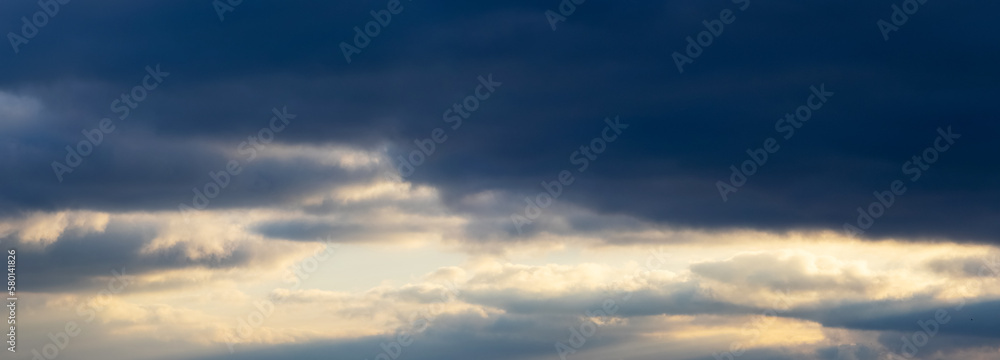 Dark clouds in the blue sky during sunset Dark clouds in the blue sky during sunset