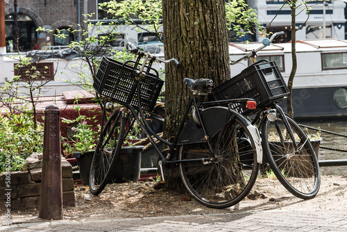 Old bicycles parked by the canal in Amsterdam, Netherlands