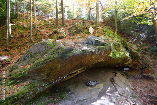 Blessed Stone and sacred spring in forest near Manyava Skete in Ukraine photo