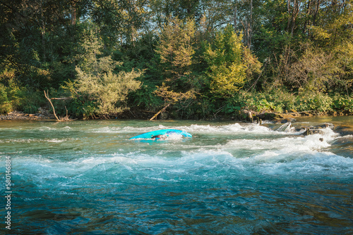 Obraz na plátně Kayaker capsized into the river while paddling
