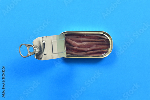 top view of a can anchovy on blue background photo