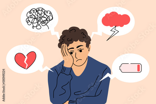 Upset guy surrounded by symptoms of depression disorder. Young man who suffers from mental health diseases. Vector illustration in cartoon flat style.
