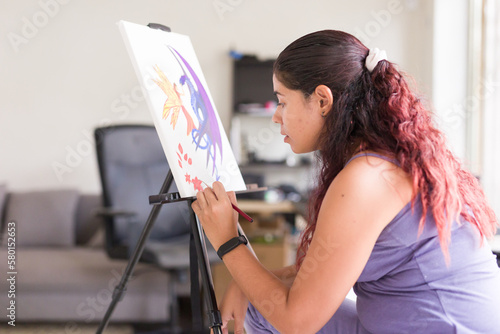 painting concentration and inspiration for mental wellbeing. south american venezuelan woman