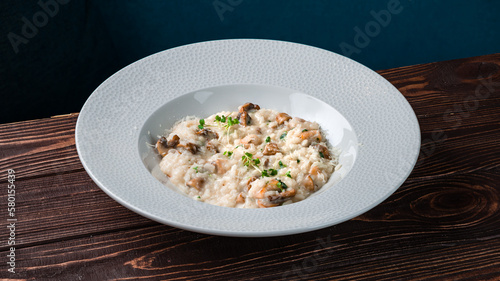 Italian risotto with parmesan, mushrooms and microgreens.
