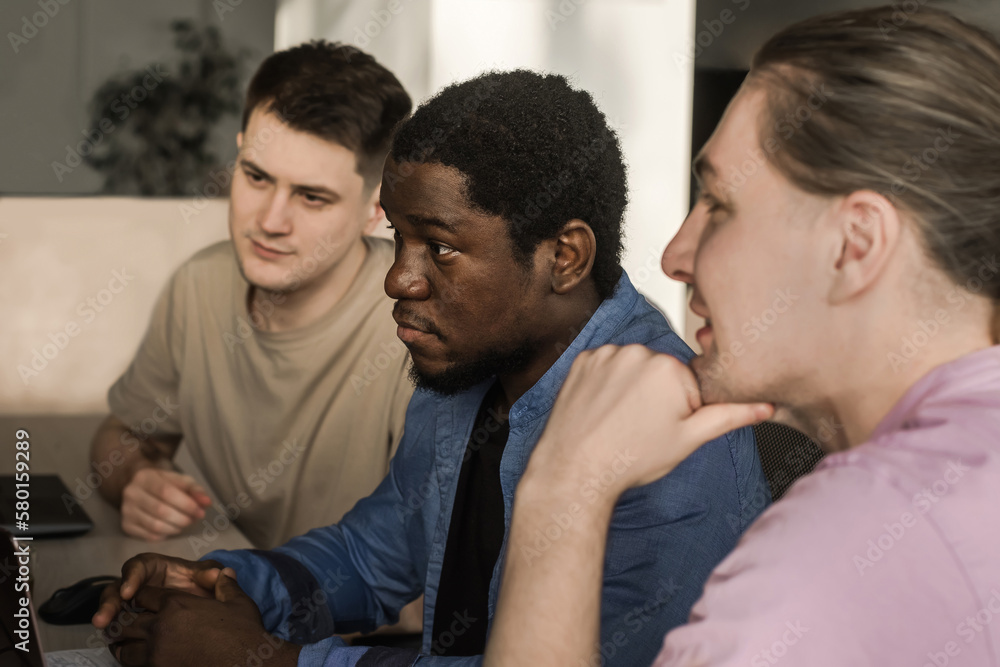 Obraz premium Programmers working in the office of a software development company. Coding technologies, site design. Successful diverse Teamwork. Cyberspace concept.
