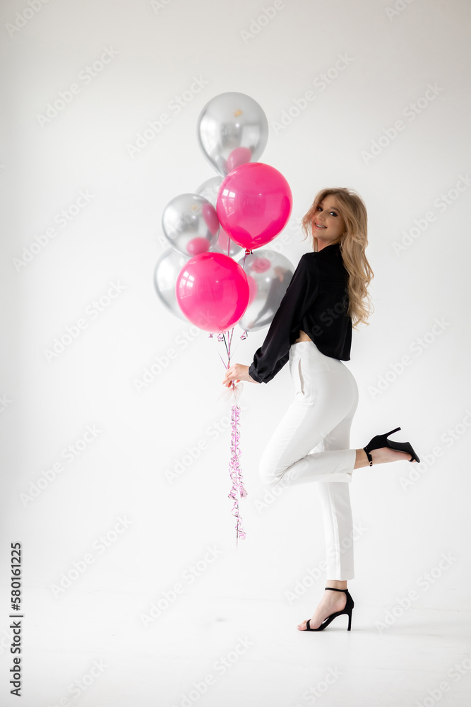Smiling blonde woman with balloons isolated on white. Girl with braces. Orthodontics treatment. Smiling blonde woman with balloons isolated on white. Girl with braces. Orthodontics treatment.