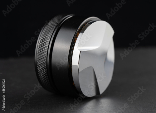 Wallpaper Mural Coffee leveler with black matte texture and shiny bottom. Barista tool for leveling ground coffee in the porta filter before extraction. Torontodigital.ca