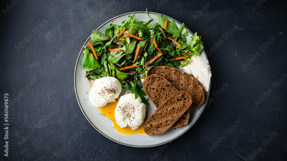 Breakfast poached eggs with salad of arugula, beets, carrots, balsamic sauce, cream cheese and toasted bread slices. Breakfast poached eggs with salad of arugula, beets, carrots, balsamic sauce, cream cheese and toasted bread slices.