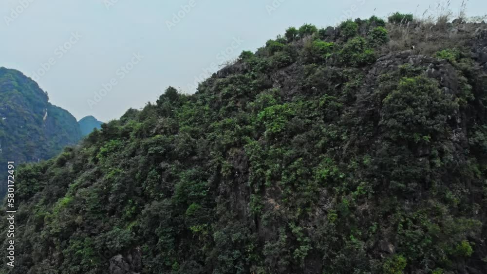 Mountain river between mountains in Ninh Binh National park, Vietnam Mountain river between mountains in Ninh Binh National park, Vietnam