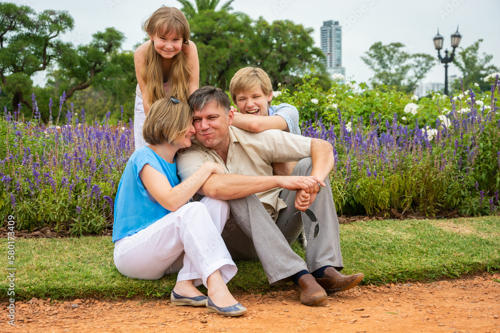 happy family relaxing in the park happy family relaxing in the park