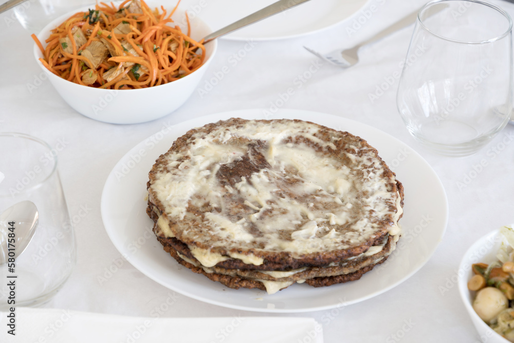 traditional festive liver cake, pie with garlic and mayonnaise on the table traditional festive liver cake, pie with garlic and mayonnaise on the table