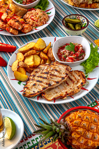 Traditional mexican food. Grilled pike perch with potato wedges. Colorful Food Table Celebration Delicious Party Meal Concept. 