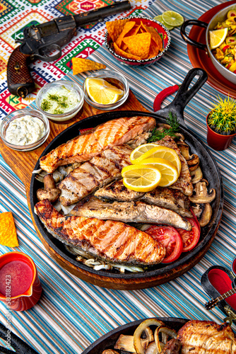 Traditional mexican food. Fish Mega grill in a pan with salmon, sea bream, trout and perch. Colorful Food Table Celebration Delicious Party Meal Concept. 