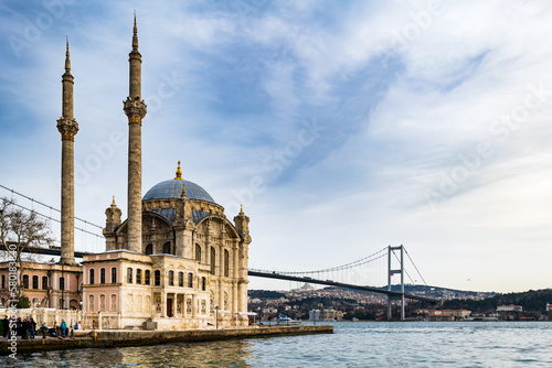 Ortakoy Mosque and the Bosporus in Istanbul, Turkey. The Bosphorus Bridge, aka the 15 July Martyrs Bridge, is a famous landmark in Istanbul, Turkey