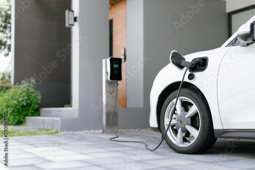 Canvas Print Progressive concept of EV car and home charging station powered by sustainable and clean energy with zero CO2 emission for green environmental