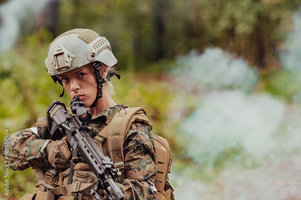 Woman soldier ready for battle wearing protective military gear and weapon