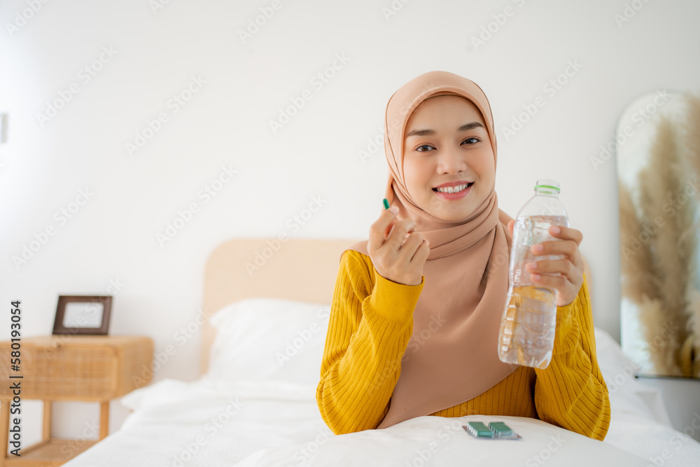 Diet, nutrition, healthy eating concept. Close Up Of Happy Smiling Asian Woman Taking Supplement Pill And Holding Glass Of Fresh Water In Morning, copy space Diet, nutrition, healthy eating concept. Close Up Of Happy Smiling Asian Woman Taking Supplement Pill And Holding Glass Of Fresh Water In Morning, copy space