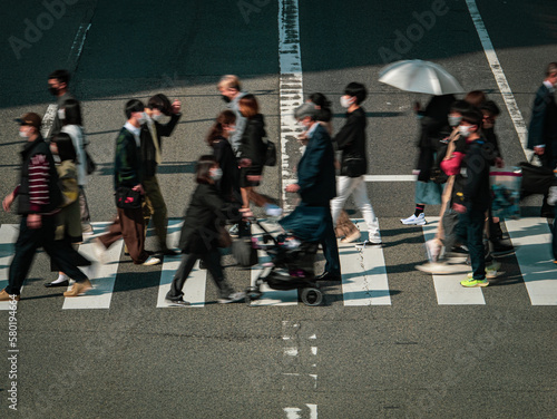 People crowd walking on a pedestrian crossing, City of Osaka in Japan, Business or work background, Blurred image