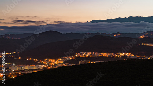 View of sunset with clouds over a town in a mountainside, Las Palmas de Gran Canaria, Spain