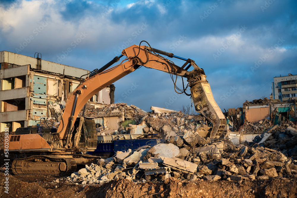 Excavator with concrete crusher at demolition site Excavator with concrete crusher at demolition site