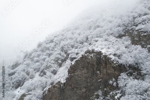 Wallpaper Mural Aerial shot of snow covered cliffs conquered by climbers Torontodigital.ca