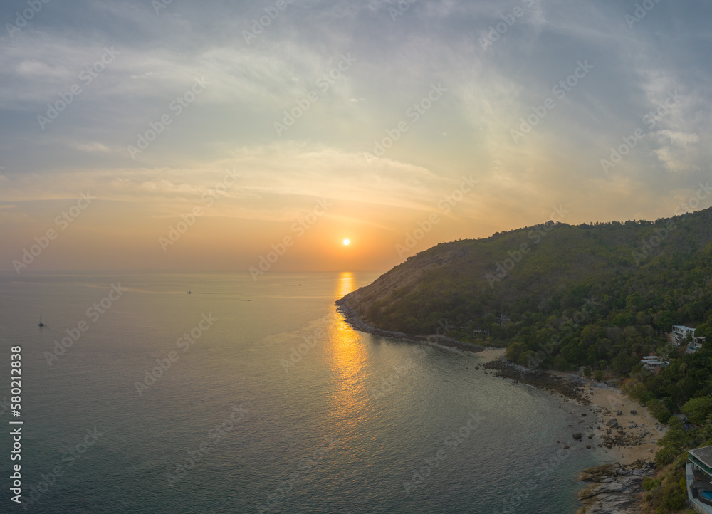 aerial view the sun going down in colorful sky impact on ocean surface.The beauty of the cliff fits perfectly with the charming nature in beautiful sunset..cloud scape background