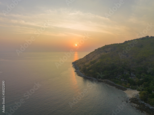 aerial view the sun going down in colorful sky impact on ocean surface.The beauty of the cliff fits perfectly with the charming nature in beautiful sunset..cloud scape background