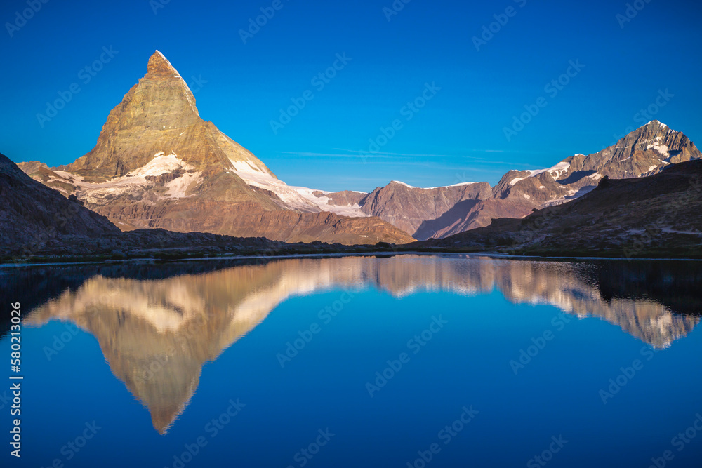 Reflection of the Matterhorn on blue lake at sunrise, Swiss Alps, Zermatt
